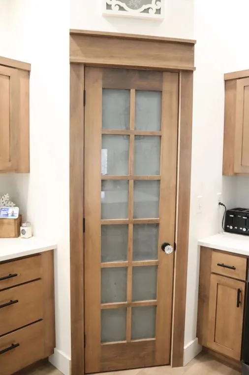 Frosted glass pantry door built to match the kitchen cabinetry — built by Amish Heritage Woodworks, Wisconsin