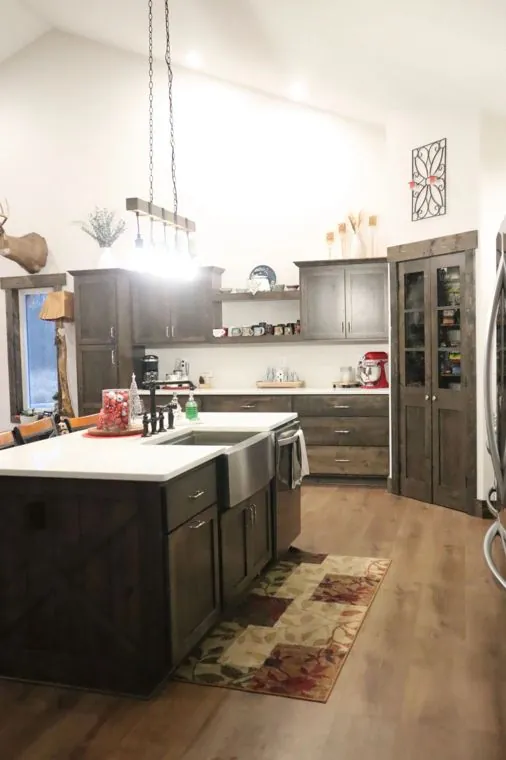 Alder kitchen with a farmhouse sink and open shelving — built by Amish Heritage Woodworks, Wisconsin