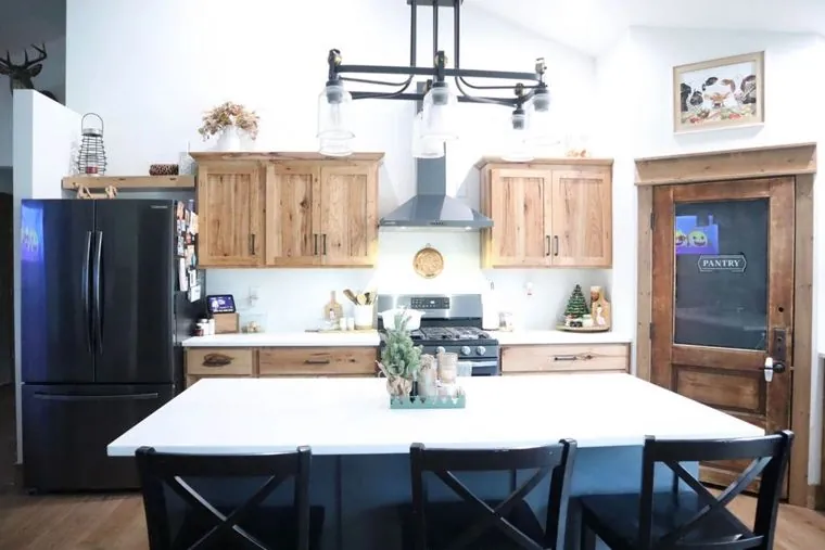 Rustic hickory kitchen with a black painted island and quartz counters — built by Amish Heritage Woodworks, Wisconsin
